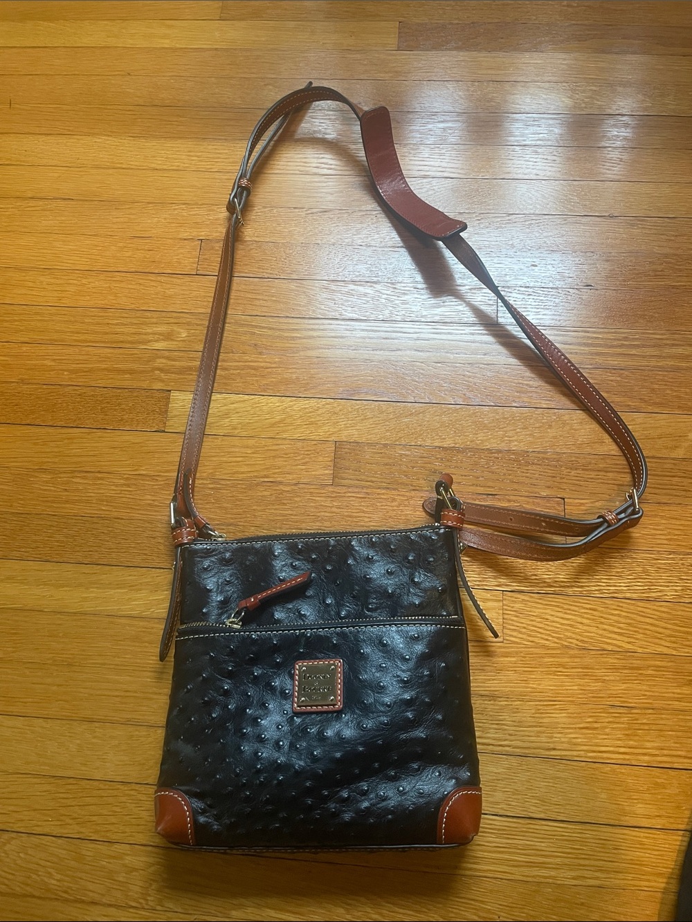 Dooney & Bourke North South Ostrich-Embossed Black with Brown Trim Crossbody Bag